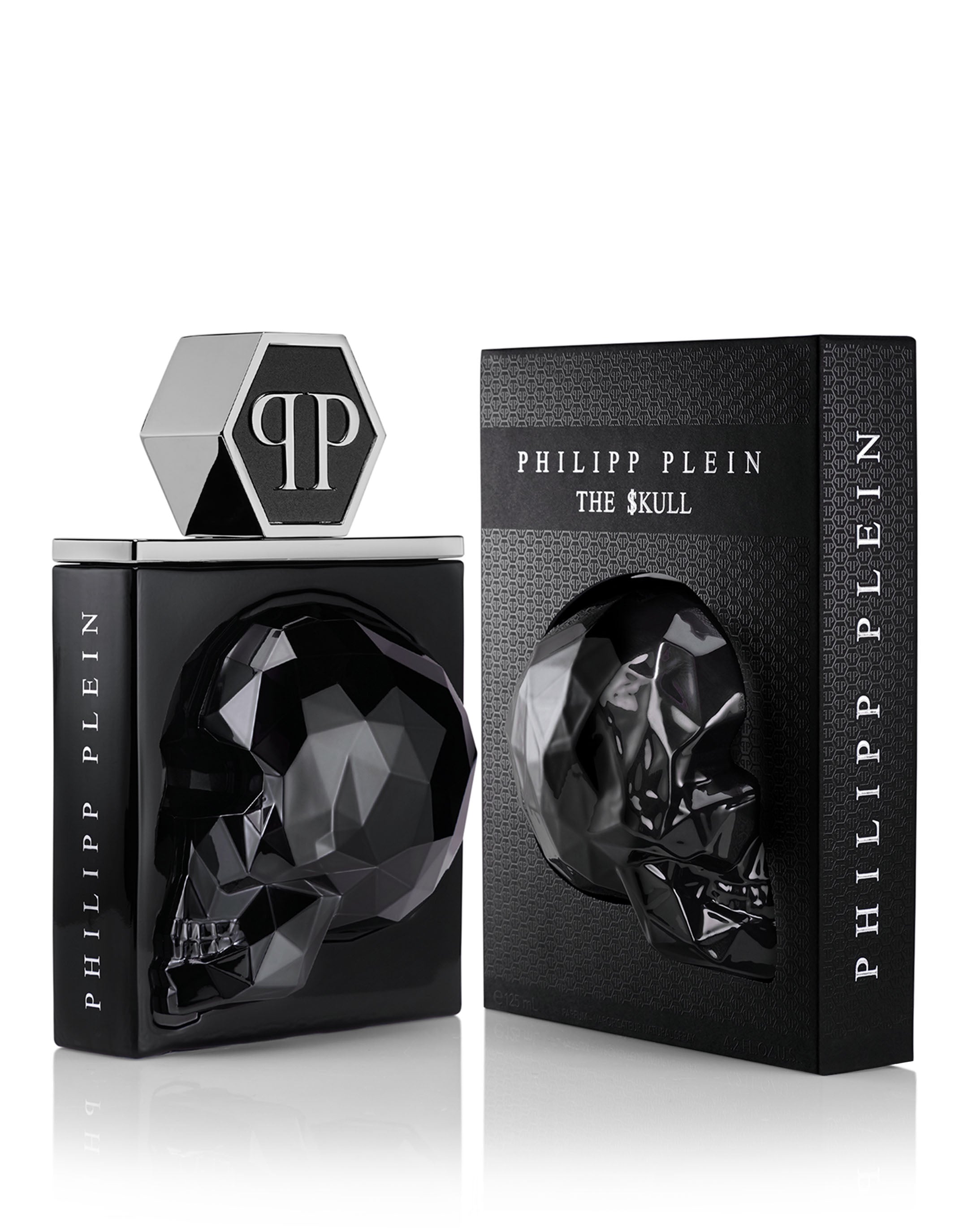 The opulent fragrance, Phillip Plein The $kull 125ml, is presented in a black skull-shaped bottle adorned with a hexagonal cap. Accompanying it is a coordinating black box showcasing an embossed skull design, highlighting this as an exquisite Perfume Art Edition creation.