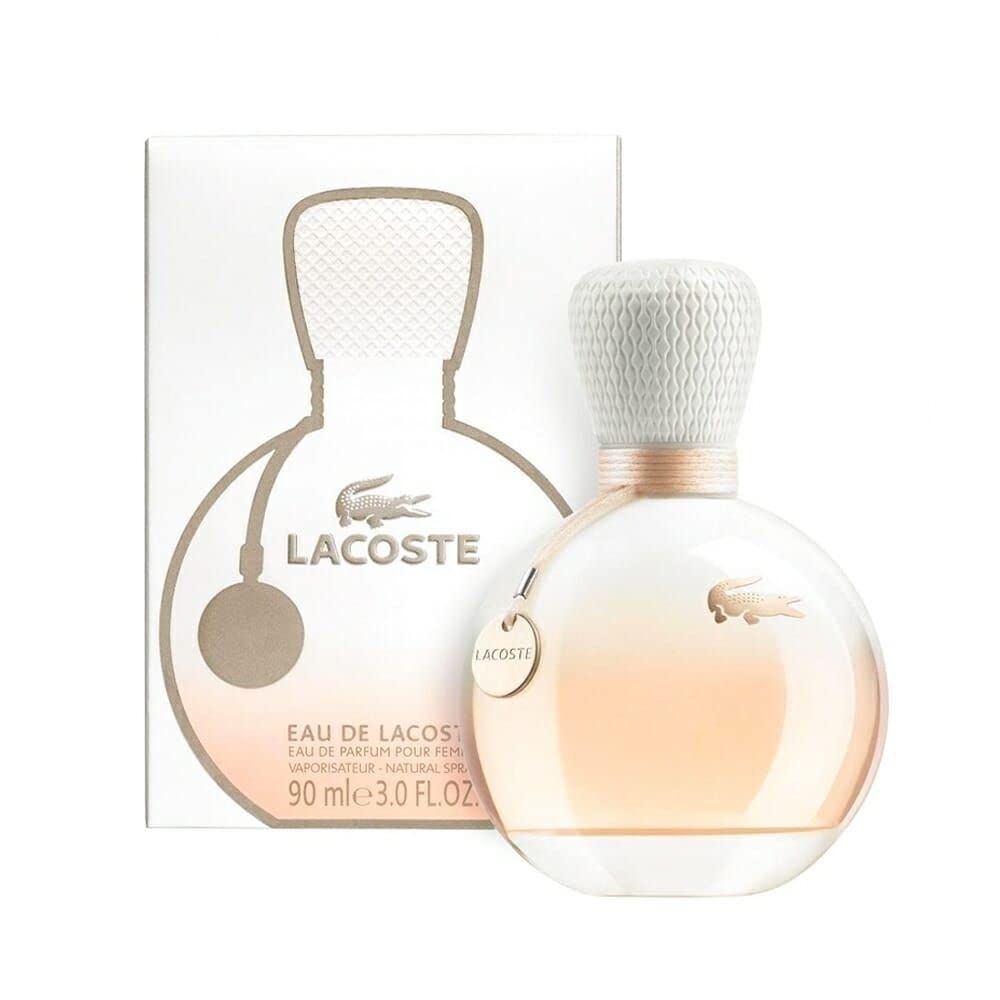 Lacoste Eau de Lacoste Pour Femme 90ml Eau De Parfum, a Floral Fruity fragrance by Lacoste, is presented in a bottle with a textured cap and packaging adorned with the iconic Lacoste logo.