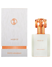 A white box labeled "Swiss Arabian Musk 07 50ml Eau De Parfum" and "Eau De Parfum" stands beside a perfume bottle with a gold and orange cap, also labeled "Swiss Arabian Musk 07 50ml Eau De Parfum" and "Swiss Arabian," offering a delightful fragrance for men & women.