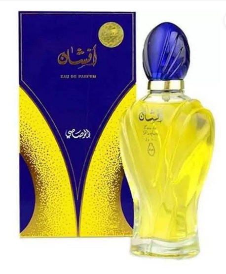 The Rasasi Afshan 100ml Eau De Parfum by Rio Perfumes features a blue-capped bottle in a matching yellow and blue box, adorned with ornate yellow designs and Arabic text, capturing the essence of an Oriental fragrance.