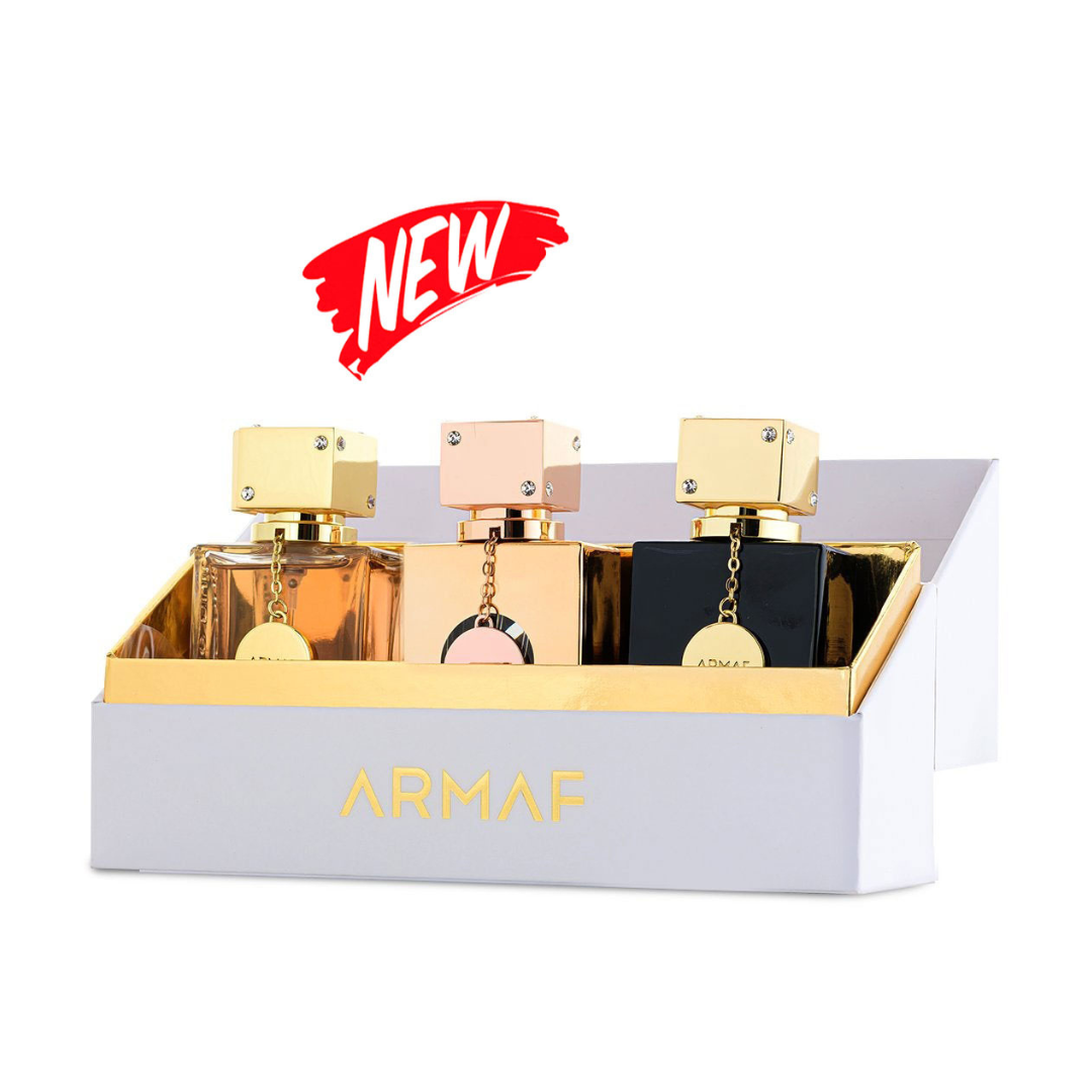 A white box with "ARMAF" elegantly displays three square perfume bottles, each with a gold label: Club de Nuit Women 30ml EDT, Club De Nuit Milestone 30ml EDP, and Club De Nuit Intense Woman 30ml EDP. A red "NEW" label highlights this limited edition gift set.