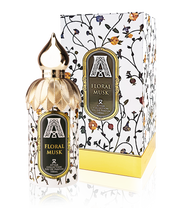 The Attar Collection Floral Musk 100ml Eau De Parfum by Rio Perfumes features a gold-capped bottle elegantly situated next to its patterned floral box, offering an exquisite fragrance experience.