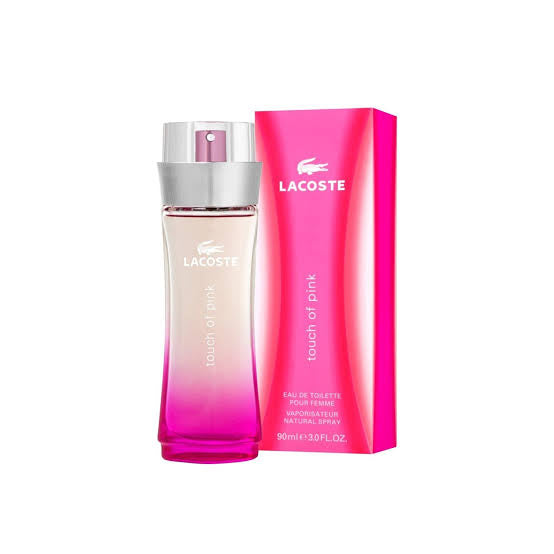 The Lacoste Touch of Pink 90ml EDT, presented alongside its pink packaging box, exudes an energetic and feminine vibe. The partially filled bottle with vibrant pink liquid and a silver cap is labeled "Touch of Pink," making it the perfect fragrance for a younger audience seeking fresh sophistication.