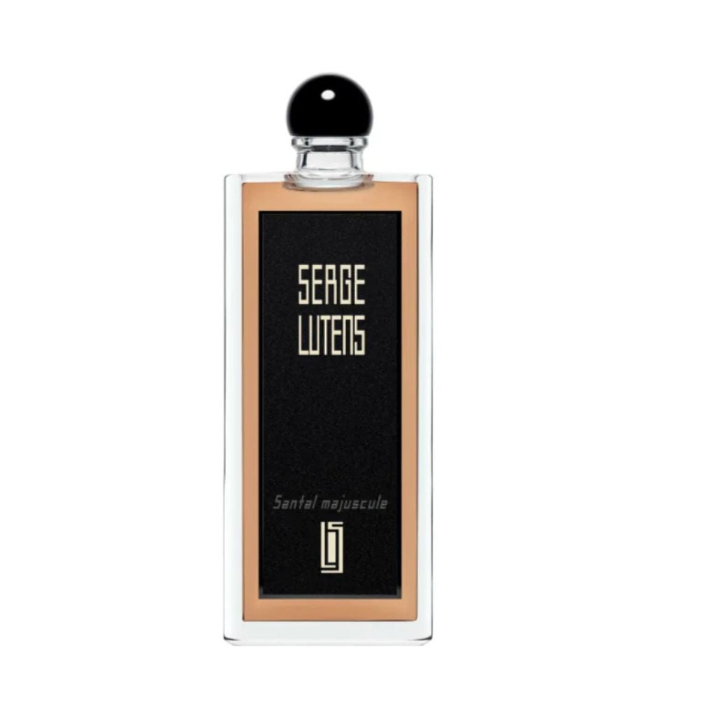 The Serge Lutens Santal Majuscule Eau De Parfum features a clear glass bottle with a black label displaying "Serge Lutens" in beige text and a black spherical cap, offering a rich sandalwood fragrance.