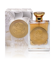 The Ard Al Zaafaran Mithqal 100ml Eau De Parfum by Rio Perfumes showcases a perfume bottle and box with intricate gold detailing, embossed Arabic text, a round gold cap, and a central ornate emblem that exudes its captivating floral fragrance.