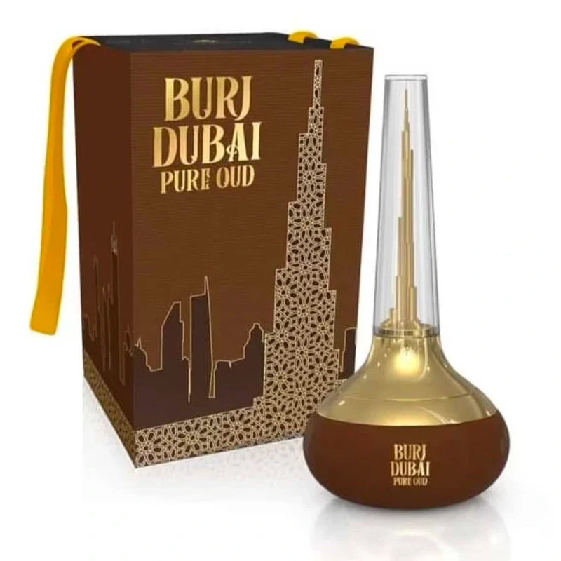 A boxed bottle of Burj Dubai Pure Oud 100ml Eau de Parfum by Dubai Perfumes features a gold and brown design, a tall conical cap, and a depiction of the Burj Khalifa on its packaging. This exquisite fragrance for men and women embodies luxury and sophistication.