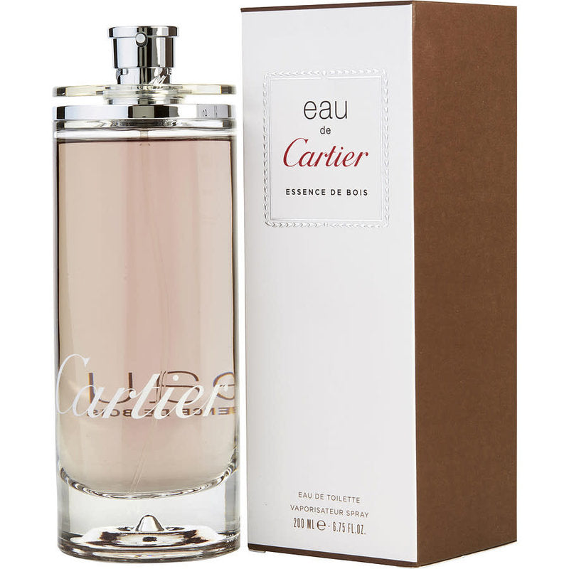 A transparent bottle of Cartier Eau de Cartier Essence De Bois 100ml Eau De Toilette stands elegantly next to a brown and white box, exuding the timeless allure of a fragrance designed for both men and women.