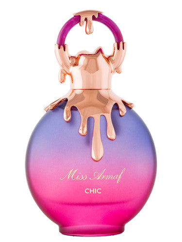 The round 100ml Miss Armaf Chic Eau De Parfum bottle showcases a pink to purple gradient design with a gold cap, embodying elegance and offering a captivating fragrance experience for women.