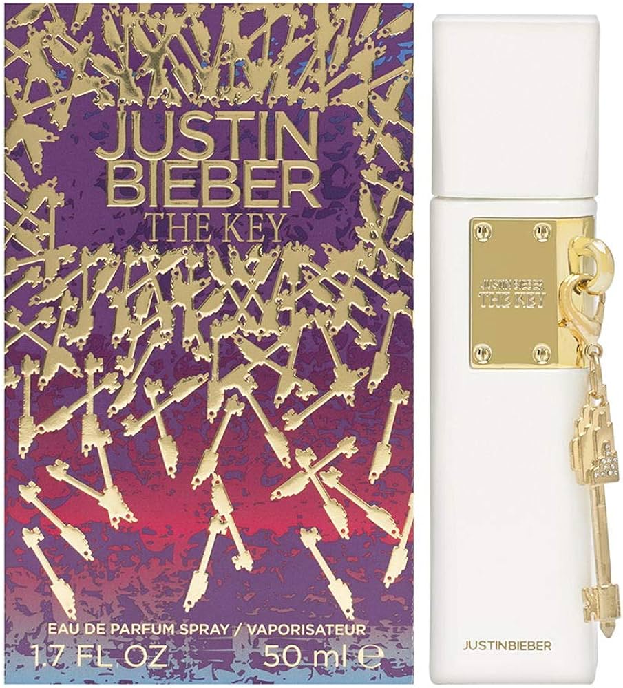 The "Justin Bieber The Key" 100 ml Eau De Parfum from the Justin Bieber brand presents luxurious perfume packaging with a golden key motif on the box. This fragrance for women is housed in a stylish, white bottle adorned with a gold key charm, exuding both elegance and sophistication.