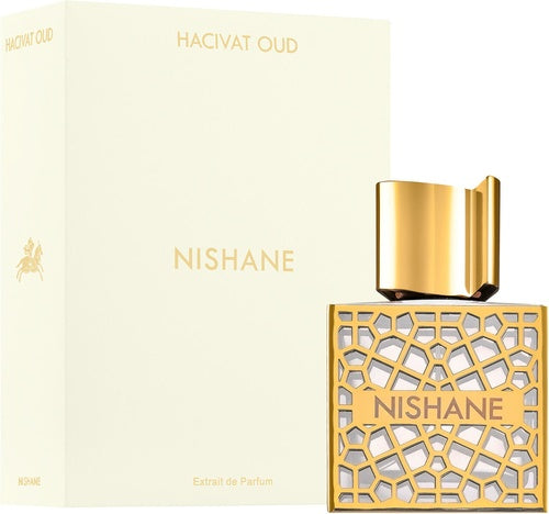 The Nishane Hacivat Oud 50ml Extrait De Parfum bottle, with its geometric gold design, sits elegantly beside its matching box, embodying luxury and sophistication in this versatile unisex fragrance.