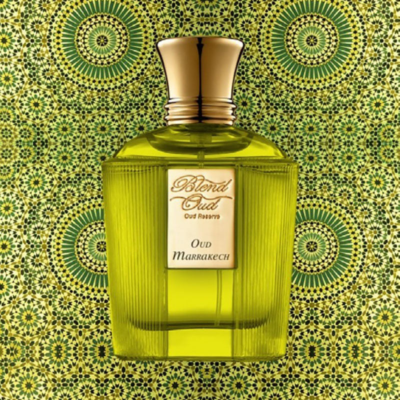 Load image into Gallery viewer, A green perfume bottle labeled &quot;Blend Oud Voyage Collection Oud Marrakech 60ml Eau De Parfum&quot; from Rio Perfumes stands against a patterned green and gold background, epitomizing a unisex fragrance for both men and women.
