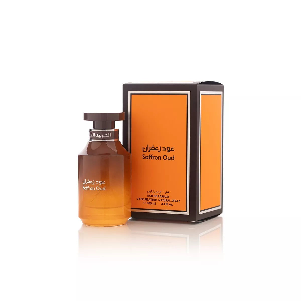 A bottle of Arabian Oud Saffron Oud 100ml Eau De Parfum by Rio Perfumes, a distinguished fragrance for men, stands beside its matching orange and black box. Text on both the bottle and the box includes the perfume name in English and Arabic.