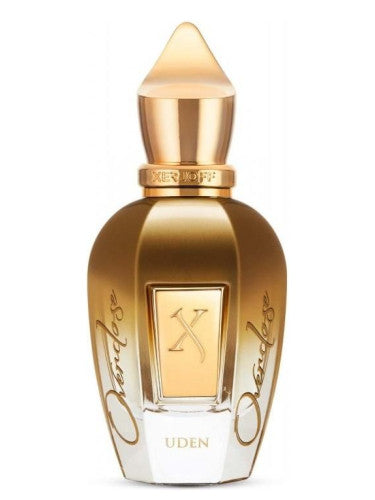 A woody and spicy fragrance, Xerjoff Uden Overdose 100ml Eau De Parfum, captured in a bottle of gold perfume placed delicately against a crisp white background.