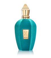 A turquoise perfume bottle with gold accents and a cap, featuring a label with the text "Xerjoff Erba Pura 50ml Eau De Parfum." This fragrance for men & women from Xerjoff offers an elegant and versatile scent.