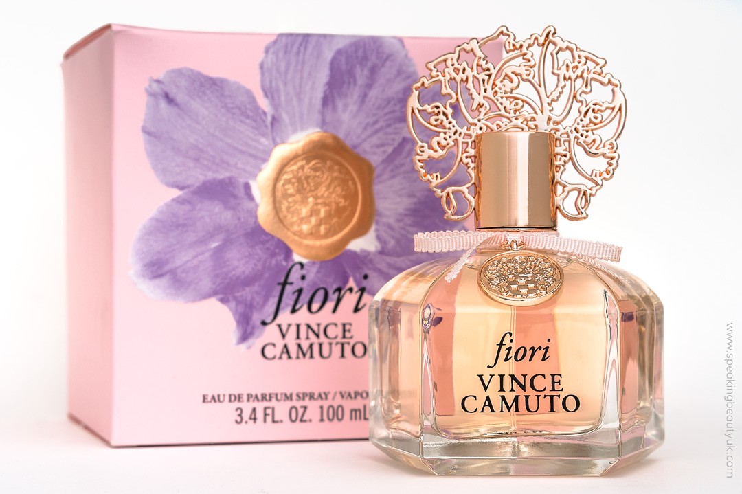 A bottle of Vince Camuto Fiori 100ml Eau De Parfum stands gracefully in front of its floral-themed box, capturing the essence of a quintessential floral fragrance.