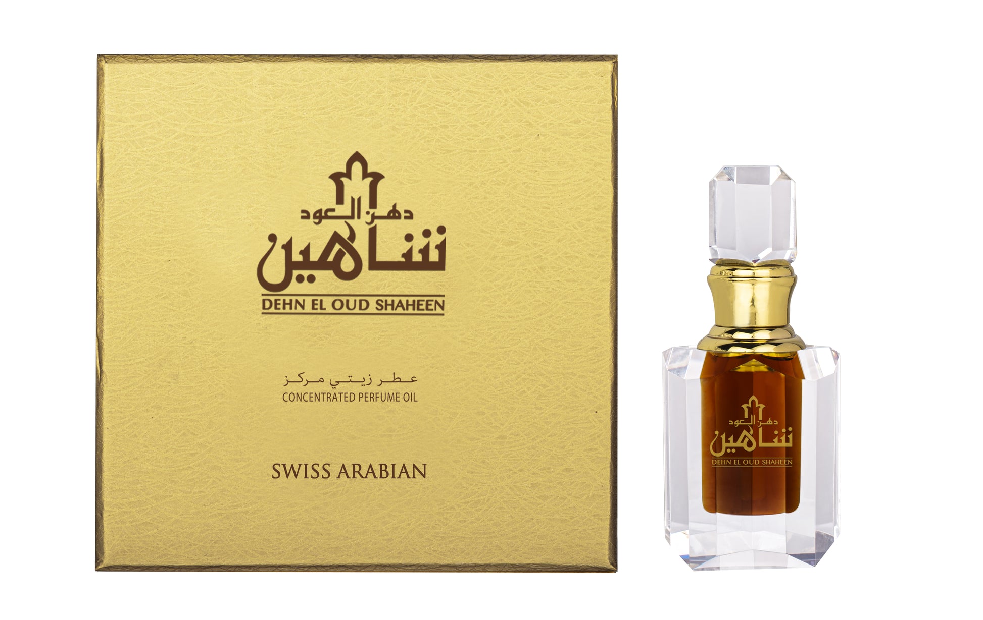 A box and a bottle of Swiss Arabian Dehn El Oud Shaheen concentrated oil. The bottle is transparent with a faceted cap and contains a dark amber oud fragrance. The box is gold-colored with Arabic text.