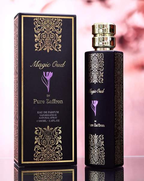 A bottle of Paris Corner Magic Oud In Pure Zaffron 100ml Eau De Parfum on a table next to a box.