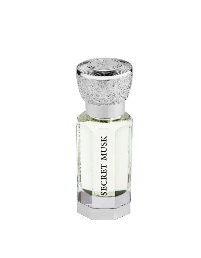 A clear hexagonal glass bottle of Swiss Arabian Secret Musk Concentrated Perfume Oil for women with a detailed silver-tone cap.