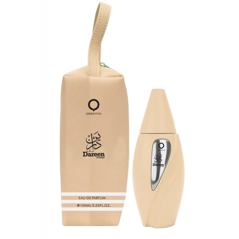 A beige bottle of Orientica Dareen Anaqa 100ml Eau De Parfum with a bag next to it featuring fruity scents.