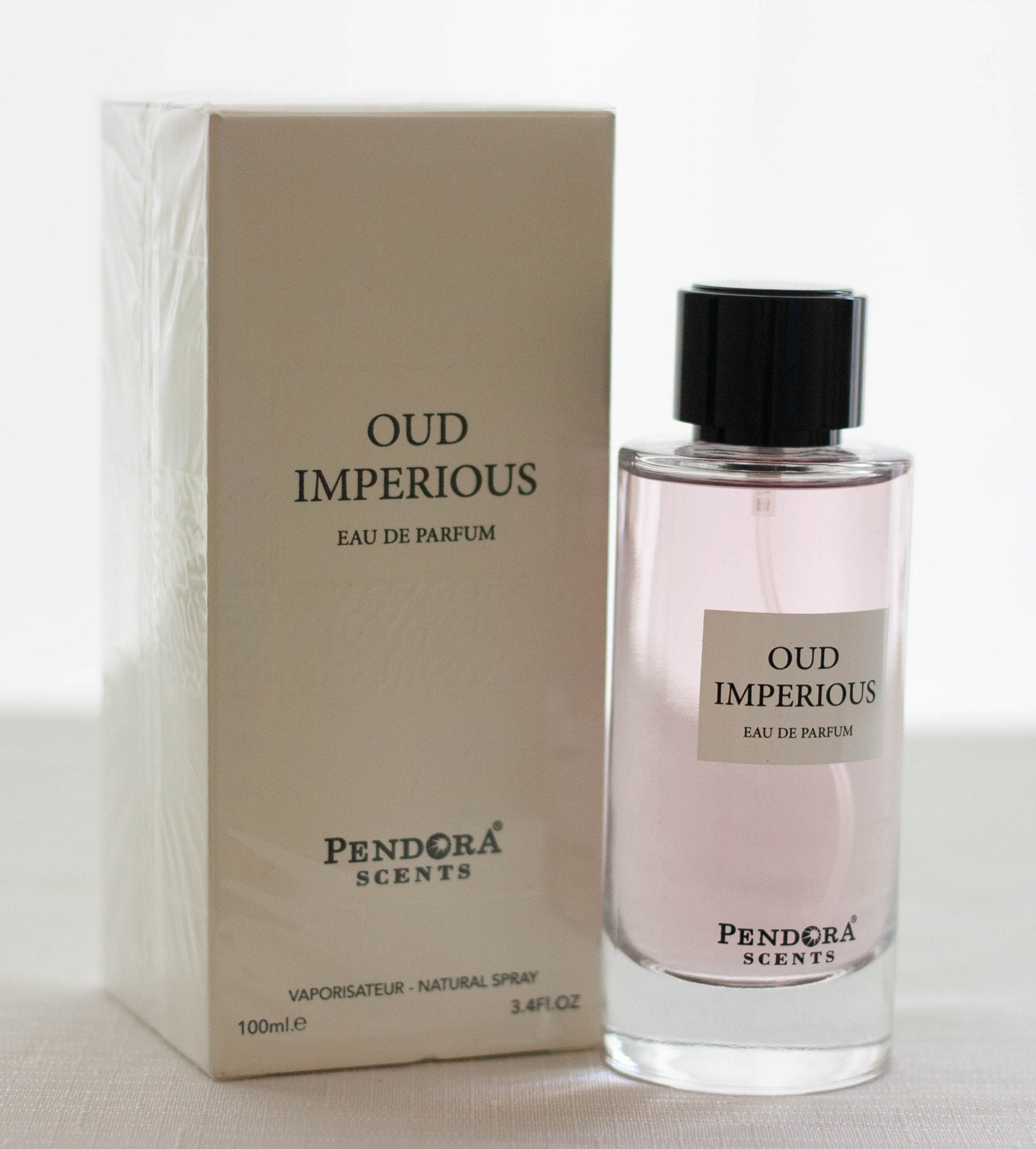 A 100ml bottle of Pendora Oud Imperious Eau de Parfum, offered as a Buy 1 Get 1 Free by Pendora, is presented alongside its stylish packaging, highlighting an alluring men's fragrance.