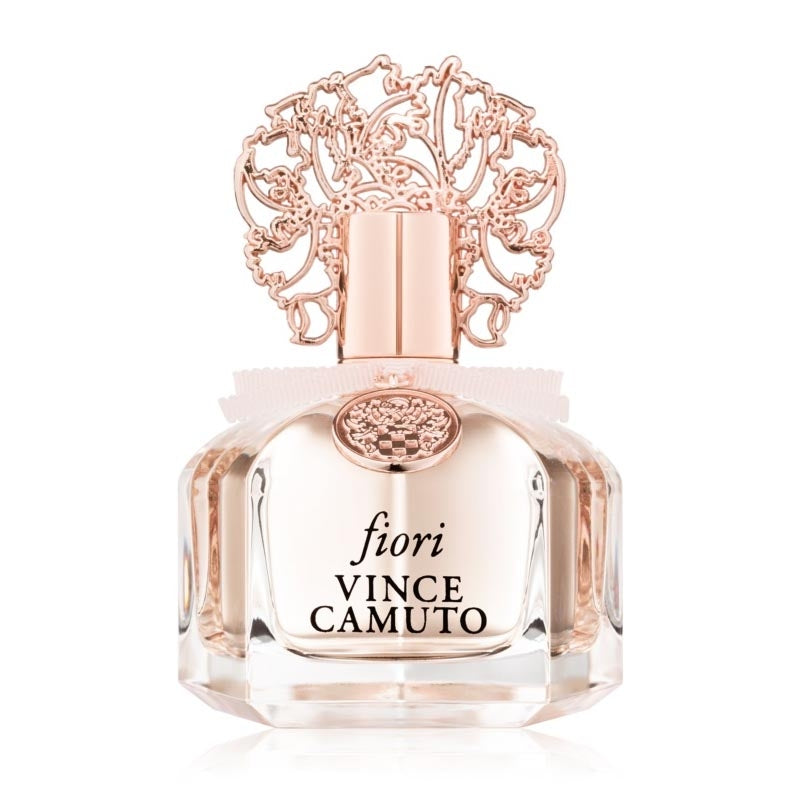 The Vince Camuto Fiori 100ml Eau De Parfum, featuring a decorative rose gold cap, captures the essence of a floral fragrance.